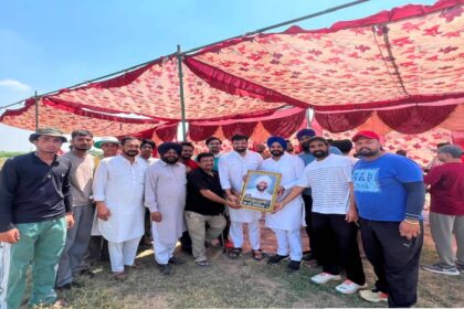 Mayor Sarabjeet Singh Samana interacts with young cricketers and organisers during a cricket tournament at Village Nagari in SAS Nagar Mohali.
